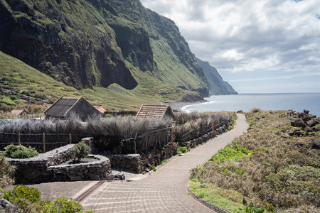 Picturesque deserted old town located on the coast under big green cliffs, Madeira, Portugalの写真素材