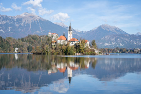 Church in the middle of lake with castle in backdrop, Bled, Slovenia, Europeの写真素材