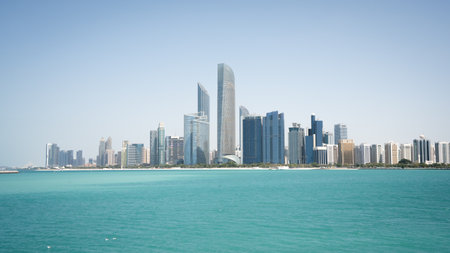 Coastal cityscape with high rise buildings and azure waters in foreground, United Arab Emiratesの写真素材