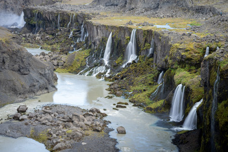 Detail of river valley with multiple massive waterfalls streaming into it, Highlands, Icelandの写真素材