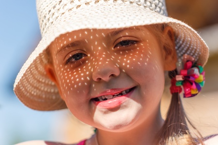 girl in a white hat smiling
