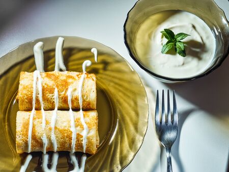 pancakes with sour cream on a plateの写真素材