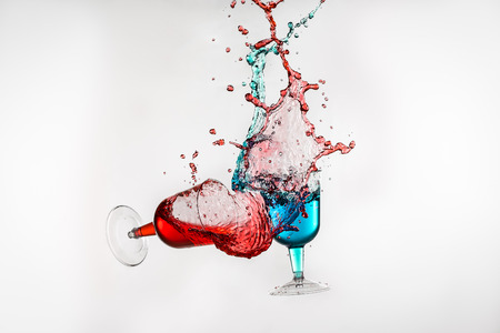 Dancing lasses with colorful liquors making liquor splashの写真素材