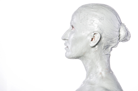 Scary woman in mud. Spa treatment.の写真素材