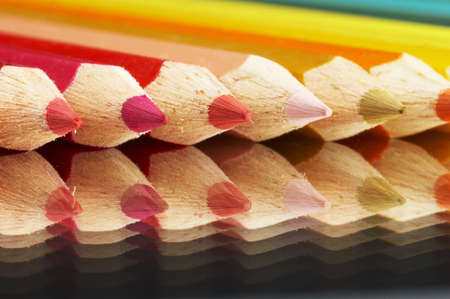 Colored crayonson a mirrow in a row in rainbow colorsの写真素材