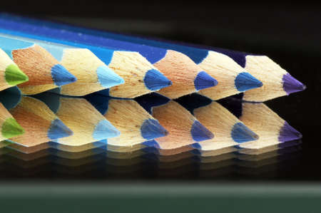Colored crayonson a mirrow in a row in rainbow colorsの写真素材