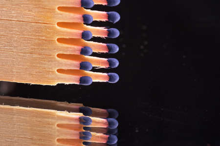 matches with blue match head in a row - landscape format - black background