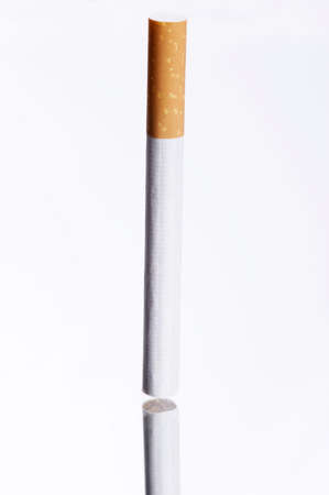 cigarette on a mirror - black and white backgroundの写真素材