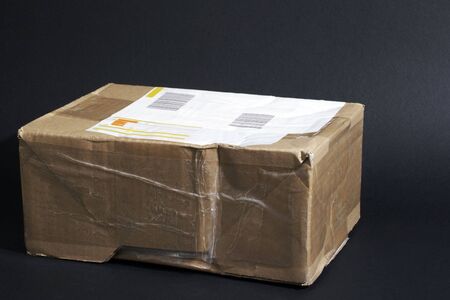 beige parcel box in front of black backgroundの写真素材