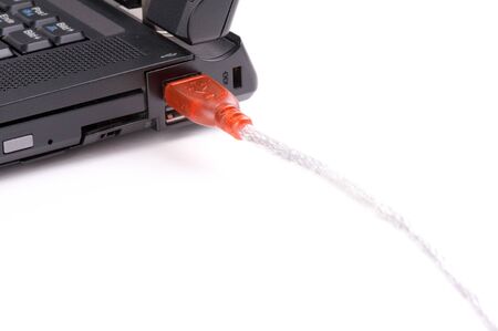 Red USB Cable connected in a black laptop - on white background