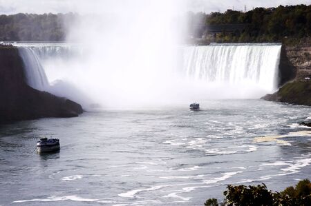 Maid of the Mist under the Horseshoe Falls (Canadian Falls) is part of the Niagara Falls located on the Niagara River on the border of Canada.の写真素材