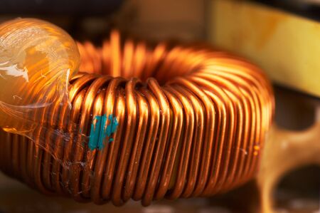 coppery spool inside a power supply - landscape formatの写真素材