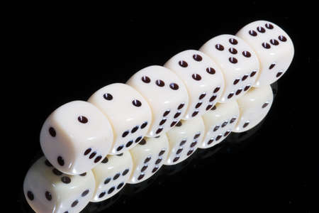 Dice in a row from one to six  on a mirror - black backgroundの写真素材