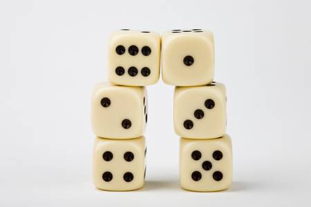 Dice towering on white backgroundの写真素材