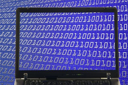 Laptop showing binary digits in backgroundの写真素材
