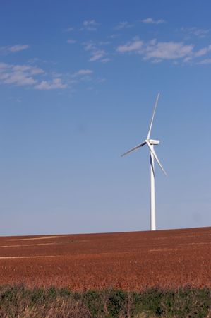 Modern windmill in a soybean field