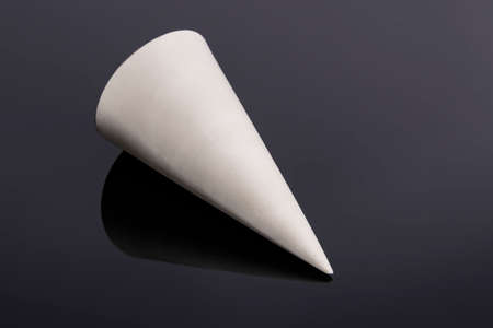 The cone is a geometric figure, a white figure on a black background. Cone 3D.の写真素材