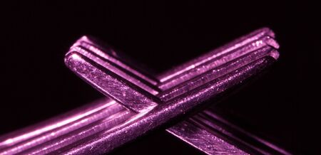 Abstract macro of interwoven tines of two forks