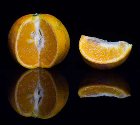Orange close up with quarter wedge removed to show juicy insideの写真素材