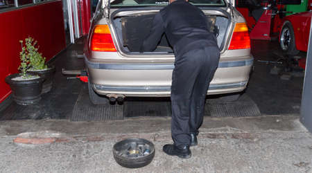 Checking spare tyre in boot of BMW at workshopのeditorial素材