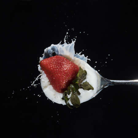 Strawberry dropping in to milk: spalsh photographyの写真素材