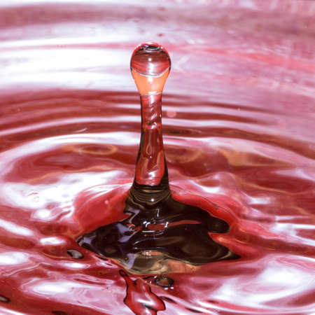 Water droplets form beautiful and psychedelic patterns in waterの写真素材