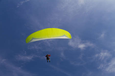 paraglider in the sky (yellow)の写真素材