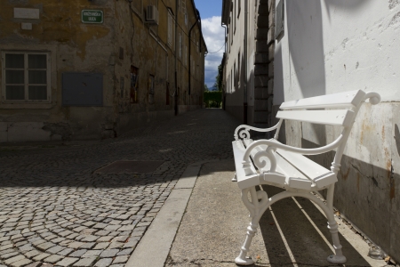 Rustic white bench in townの写真素材