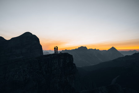 Silhouette of a couple during a morning sunrise in the mountains of Italyの写真素材