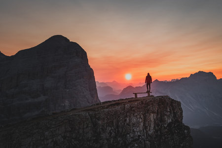 Silhouette of a person during a morning sunrise in the mountains of Italyの写真素材