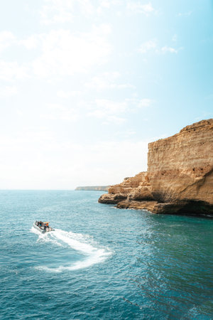 Tourist Boat exploring the Atlantic Ocean at Carvoeiro, Algarve, Portugalの写真素材