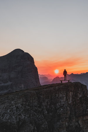 Silhouette of a person during a morning sunrise in the mountains of Italyの写真素材