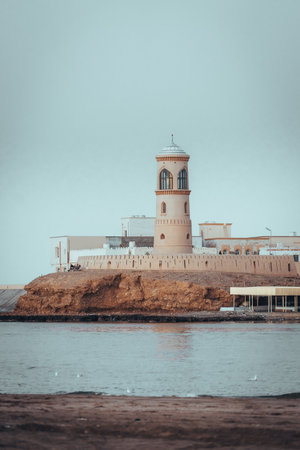 View on the light house at sea in coast town Sur, Oman during sunset