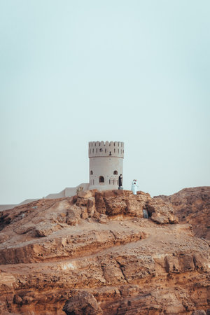 View on the watch tower in coast town Sur, Oman during sunsetの写真素材