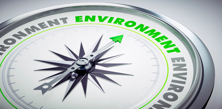 White and green compass with needle pointing to the word environmentの写真素材
