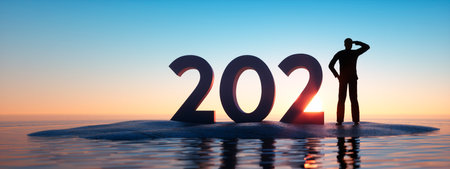 Silhouette of man and 2020 concept in beautiful sunset sky and sea backgroundの写真素材