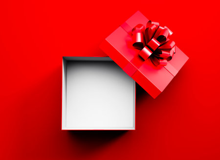 White and red opened empty gift box with red ribbon isolated on red backgroundの写真素材