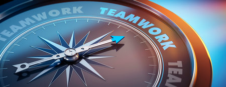 Dark compass with needle pointing to the word teamworkの写真素材