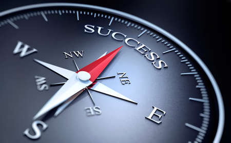 Black Compass with silver and red needle pointing at the word successの写真素材