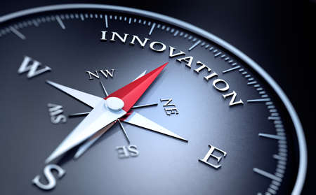 Black Compass with silver and red needle pointing at the word innovationの写真素材