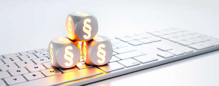 Dice with paragraph symbols on white computer keyboard - 3D illustration