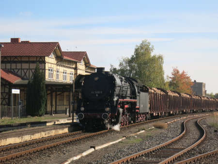 Freight train leaves, steam locomotive pulls