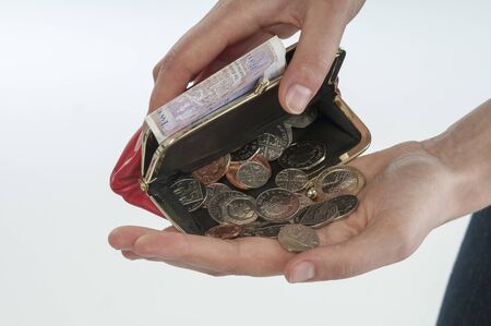 Woman holding purse with cash in her handの写真素材
