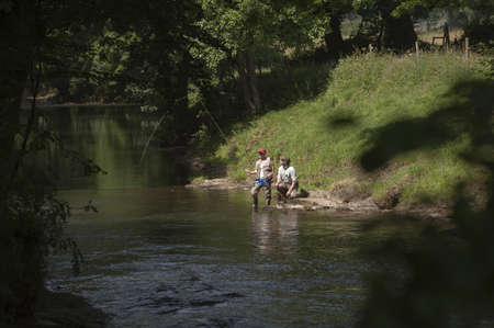 Fly fishing a gillie instructing a pupil River Lyd Devon UKの写真素材