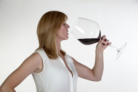 Woman with a very large glass of red wineの写真素材