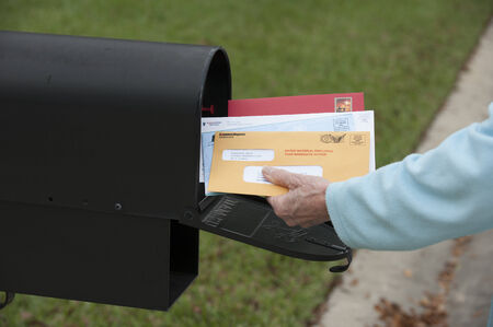 US mail box Hand removing the mail
