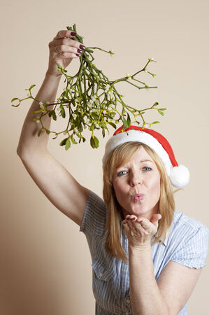 Mistletoe Woman holding a bunch of the festive decorationの写真素材