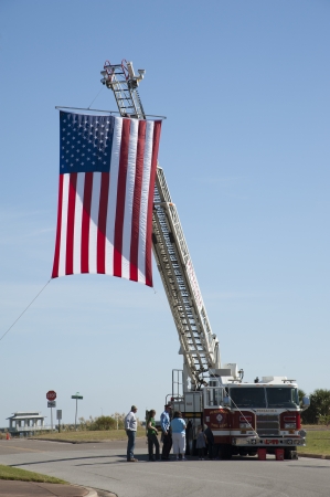 Pensacola Fire Department truck flying a large Stars and Stripes flag  Veterans Day USAのeditorial素材