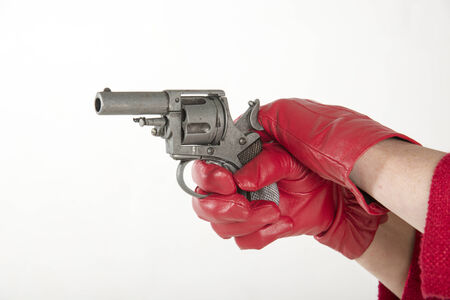 Woman wearing red glove holding a gun