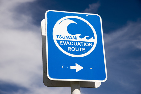 Tsunami flood evacuation route roadside sign in Napier New Zealandの写真素材